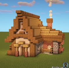 a house made out of wood and bricks in the middle of a field with clouds above it