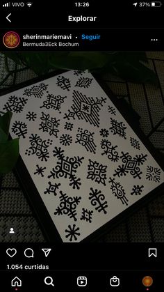 an image of a black and white snowflake pattern on a cell phone screen