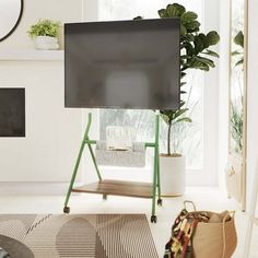 a flat screen tv sitting on top of a wooden stand