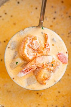 a bowl filled with soup and shrimp on top of it