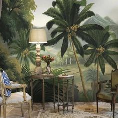 a living room with palm trees painted on the wall and chairs in front of it