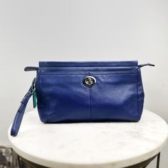 Coach Park Pebbled Leather Clutch Wristlet Blue Green Nwt Dimensions: 7.5" X 4.75" X 1.4"; 5" Wrist Strap (Detachable) Zip-Top Closure Interior Slip Pocket Exterior Slip Pocket Green Satin Lining Silver Tone Hardware Condition Is New Without Tags! Style # F49472 Blue Leather Travel Pouch, Blue Bag With Snap Closure For On-the-go, Blue Leather Rectangular Pouch, Blue Coach Clutch For Everyday Use, Coach Blue Clutch For Everyday Use, Blue Pouch With Zipper Closure For On-the-go, Blue Zipper Pouch For On-the-go, Blue Zipper Pouch For Travel, Blue Zipper Closure Pouch For On-the-go