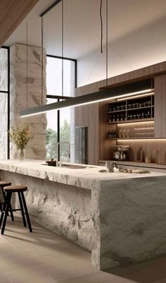 a modern kitchen with marble counter tops and stools in front of the bar area