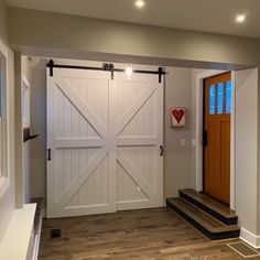 an empty room with two wooden doors and steps leading to the front door is shown