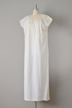 "This Victorian night gown is made from soft, off-white cotton in a beautiful, simple design. The top has a yoke of crocheted cotton lace, with a rounded, drawstring collar. Dolman-like sleeves transition into the straight cut skirt of the piece. Would look great belted, or on its own as a summer day look. Pullover fit. Size: M, L, XL. Bust: 52\" Waist: 56\" Hips: 56\" Length: 58\" Label: None. Condition: Excellent vintage condition (tiny pin-hole near front hem). All vintage is sold in \"as-is\ Cotton Delicate Lace Dress For Daywear, Cotton Lace Trim Sleepwear For Wedding Night, Cotton Nightgown With Lace Trim For Wedding Night, Elegant Cotton Dress For Wedding Night, Elegant Fitted Cotton Nightgown, Cotton Summer Nightgown For Weddings, Cotton Nightgown For Summer Weddings, Summer Cotton Nightgown For Wedding, Summer Cotton Wedding Nightgown