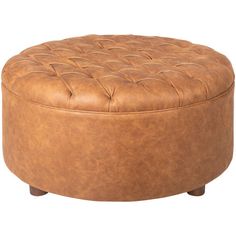 a round leather ottoman sitting on top of a wooden table