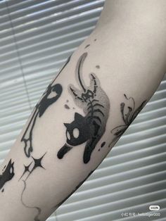 a person with a cat tattoo on their arm