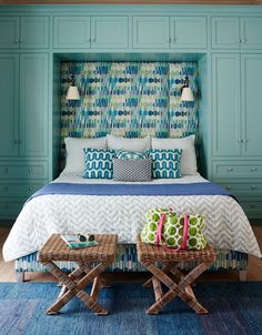 a bedroom with blue and green decor on the walls