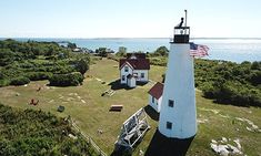 an aerial view of two lighthouses with the ocean in the background