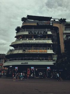 people are walking around in front of a large building