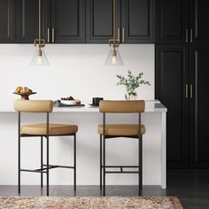 two stools in front of a kitchen island with food on the counter and an area rug