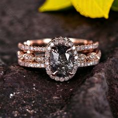 a close up of a ring on a rock with flowers in the background