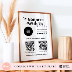 a wooden shelf with a framed poster on it and a vase next to it that says connect with us