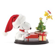 a white dog with a christmas tree and presents