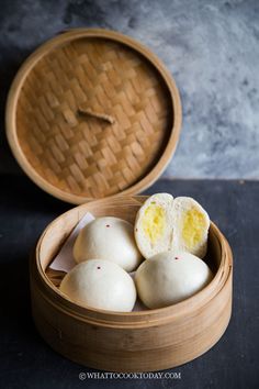 some kind of food that is in a wooden container on a table with a black surface