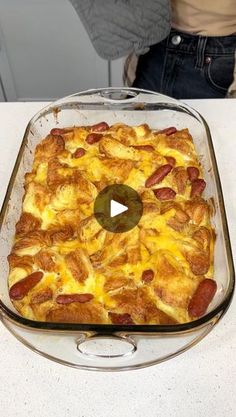 a casserole dish with sausage and cheese in it on a white counter top