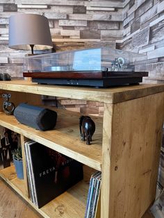 a record player on top of a wooden shelf