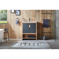 a bathroom with wooden walls and a rug on the floor