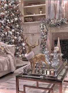 a living room decorated for christmas with silver and gold decorations