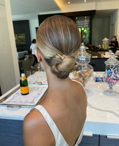 a woman with blonde hair in a low bun