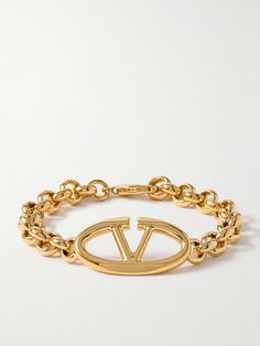 Valentino Garavani's bracelet is centered with the latest 'Bold' version of its 'VLOGO' emblem, which has curved edges. It's made from gold-tone metal and strung with chunky chain links, so it looks just as good solo or stacked with daintier styles. Designer Gold Bracelets With Logo Charm, Designer Gold Jewelry With Logo, Luxury Gold-tone Jewelry With Logo, Luxury Gold-tone Logo Jewelry, Classic Gold Jewelry With Logo, Formal Yellow Gold Bracelets With Gold-tone Logo, Luxury Gold-tone Bracelet With Logo Charm, Luxury Gold-tone Logo Plaque Bracelet, Designer Jewelry Bracelet With Logo Charm