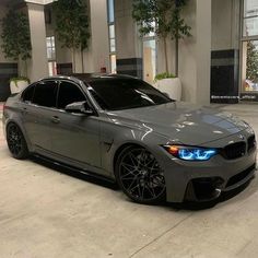 a grey car parked in front of a building