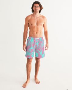 Men's Swimsuit, Tropical Foliage Pink and Teal Blue Pink and Teal Tropical Floral Leaf swim trunks. Bright turquoise blue and vibrant pink tropical foliage print Product Details Head to the beach in our classic fit Men's Swim Trunks made with comfort in mind. With an adjustable drawstring waistband, its smooth and durable materials made with UPF 50+ gives you premium UV protection. Soft, lightweight fabric Drawstring waistband UPF 50+ Built-in mesh brief Two side, one back slip pocket Printed, c Pink Swim Trunks For Beach Vacation, Tropical Swim Trunks For Summer, Pink Beachwear Swim Trunks For Vacation, Tropical Style Swim Trunks With Tropical Print For Vacation, Hawaiian Style Swim Trunks For Beach Party, Tropical Print Swim Trunks For Vacation, Tropical Swim Trunks For Beach Season, Green Tropical Swim Trunks For Summer, Casual Pink Swimwear With Tropical Print