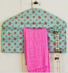 a pink and blue scarf hanging from a hook