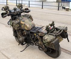 a camouflaged motorcycle is parked on the street