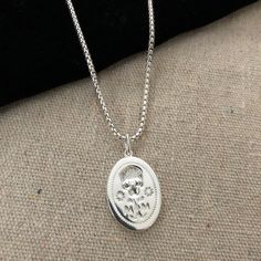 Our pendant was designed to follow our signet ring which is based on a Renaissance Memento Mori from 1600. Memento Mori jewelry has been worn for hundreds of years as a way to remember loved ones who have passed on. Worn on a sterling silver round box chain at 18" long with a 2" extension. All orders over $50 ship for free within the USA. All orders usually ship within 24 hours from the USA. Sterling Silver Locket Necklace For Commemoration, Memorial Sterling Silver Oval Pendant Jewelry, Sterling Silver Oval Pendant For Memorial, Elegant Silver Jewelry For Commemoration, Sterling Silver Necklaces For Commemoration With Polished Finish, Antique Sterling Silver Oval Link Jewelry, Sterling Silver Necklaces With Polished Finish For Commemoration, Sterling Silver Round Pendant Necklace For Commemoration, Sterling Silver Oval Link Jewelry Stamped 925