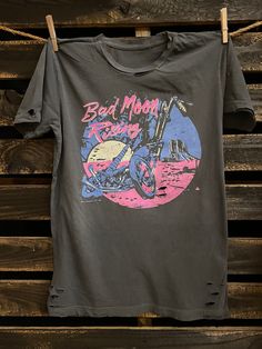 Country Deep Bad Moon Rising 80's vintage unisex distressed T shirt in vintage wash black Throw back vintage tee from 1980's 40 Singles Jersey 100% Cotton Premium quality ringspun and compacted cotton Fine Cotton Jersey that is pigment dyed for a more vintage look Features tears and destroyed features at neck and on body Each piece is unique as this process is done by hand! 3.8 oz Made In USA Every garment dye item can be a slightly different shade in color since this is a laundry dye process. E Distressed Acid Wash Band Merch T-shirt, Retro Black Soft-washed T-shirt, Retro Distressed Faded T-shirt, Distressed Tri-blend Graphic Tee, Vintage Acid Wash Distressed T-shirt, Acid Wash Distressed Band Merch T-shirt, Retro Washed Black Screen Print T-shirt, Retro Washed Black T-shirt With Screen Print, Retro Distressed Washed Black T-shirt