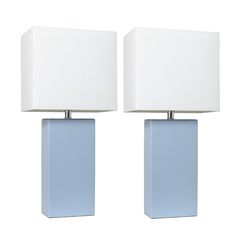 two blue and white lamps sitting next to each other