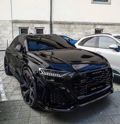 two black cars parked next to each other