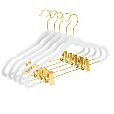 a bunch of white and gold clothes hangers on a white background with clippings