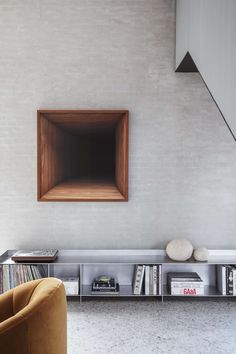 an empty room with a book shelf and chair