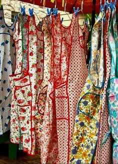 many different colored dresses hanging on a rack