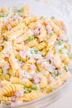 pasta salad with ham and peas in a glass bowl