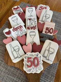 decorated cookies are arranged in the shape of wine bottles