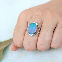 Split Band Sterling Silver Ring With Aurora Opal, Bold Oval Shape Engagement Ring, Women's Birthday Gift For Her Opal is a mesmerizing gemstone known for its iridescent play-of-color, which gives it a unique and captivating appearance. The term "Aurora Opal" could refer to any opal displaying a stunning array of colors reminiscent of the Northern or Southern Lights (Aurora Borealis or Aurora Australis). These opals often exhibit a brilliant interplay of colors when viewed from different angles. Oval Opal Birthstone Ring For Gift, Nickel Free Oval Opal Ring For Anniversary, Adjustable Oval Opal Ring For Gifts, Silver Oval Ring For Birthday, Handmade Oval Opal Ring For Anniversary, Aurora Opal, Aurora Australis, Southern Lights, Friendship Day Gifts