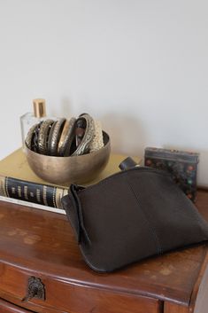 simple leather makeup bag with stitched center seam and leather zipper pull. measures 7.5" x 5". made in california. erica tanov Black Leather Pouch Cosmetic Bag, Black Leather Cosmetic Bag With Zipper, Leather Coin Purse Pouch For Daily Use, Leather Pouch Coin Purse For Everyday Use, Leather Coin Purse Pouch, Black Leather Cosmetic Bag For Daily Use, Versatile Leather Cosmetic Bag, Versatile Leather Cosmetic Bag For Daily Use, Black Leather Clutch With Zipper Pouch