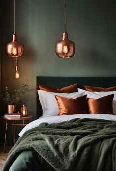 a bedroom with green walls and copper colored lights hanging from the ceiling over the bed