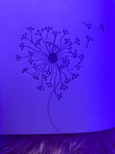 a purple paper with a drawing of a dandelion in the center on it