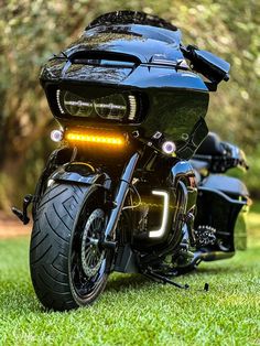 two motorcycles parked on the grass near each other