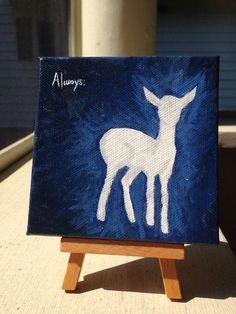 an acrylic painting of a white deer on a blue background