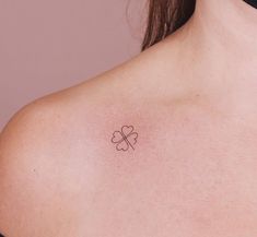 a woman with a clover tattoo on her chest