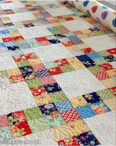 a close up of a quilt on a bed