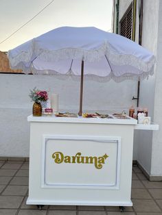 a white bar with an umbrella on top