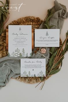 the wedding stationery is laid out on a woven basket with greenery and foliage