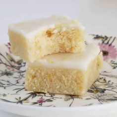 two pieces of cake sitting on top of a flowered plate with one piece cut in half