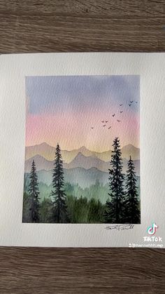 watercolor painting of mountains and trees with birds flying in the sky at sunset or dawn